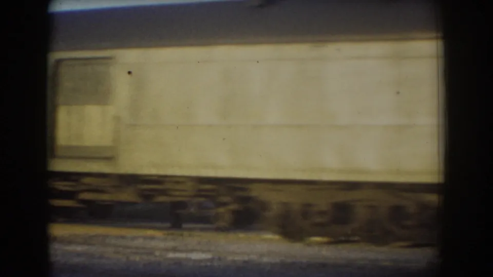 Final frame of the York, Nebraska train passing sequence, showing a long pale car side, small window area, undercarriage, and tracks.