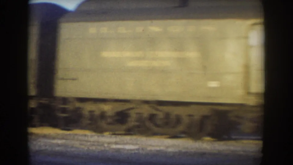The final frame shows a beige freight car passing on tracks in 1958 York, Nebraska home-movie footage.