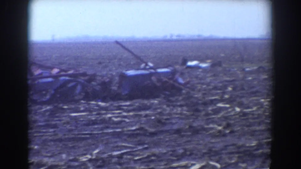 Rural tornado damage in York, Nebraska, with wreckage spread across flattened ground and no people visible.