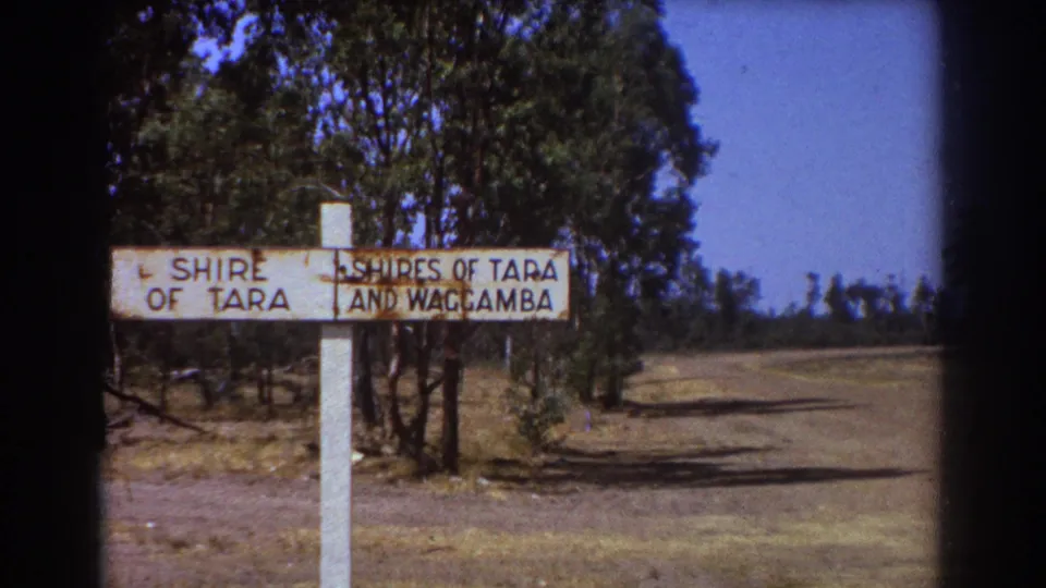 The Shire of Tara and Waggamba sign appears beside a quiet road with trees and dry ground, consistent with the 1967 Australian clip metadata.
