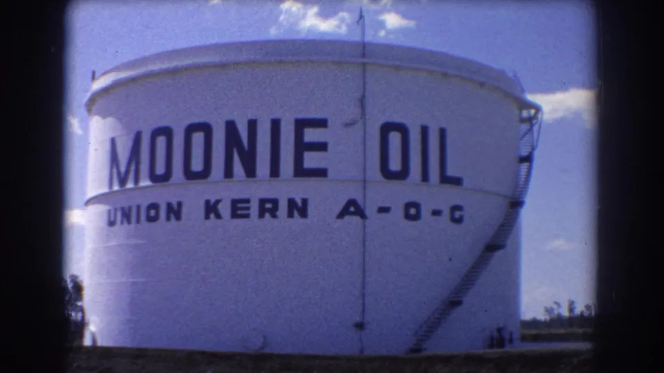Large white oil storage tank in Brisbane with MOONIE OIL and Union Kern A-O-C lettering visible on the curved wall.