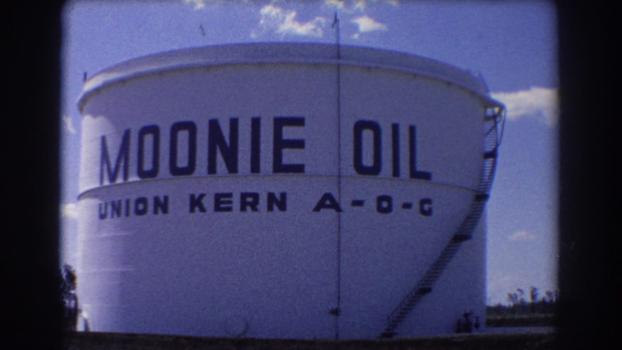 1967 Brisbane 8mm frame showing a large white Moonie Oil tank with Union Kern A-O-C lettering and a ladder at the side.