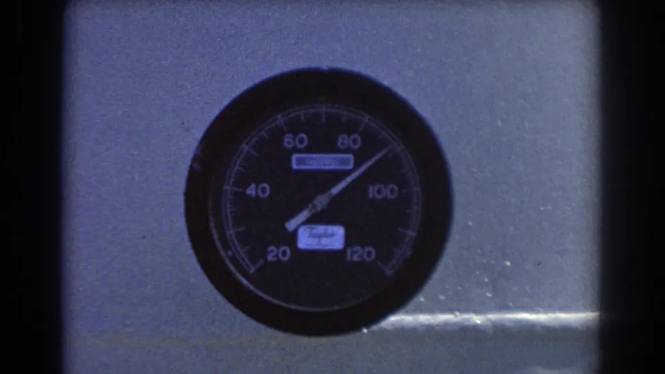 Close-up of a Taylor analog pressure gauge on a gray metal panel, with the needle near the upper range.