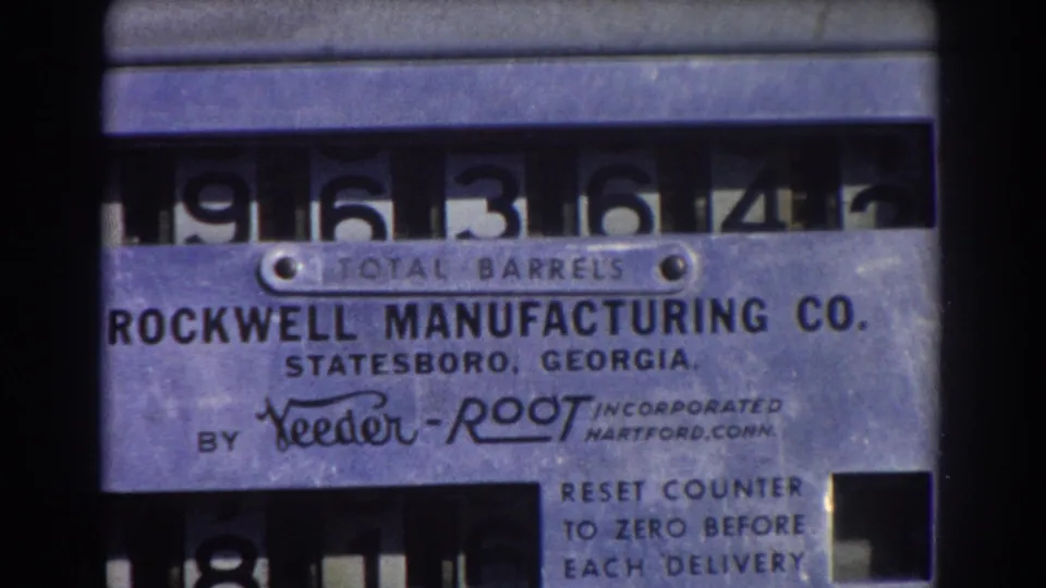 Close 8mm frame of the metal barrel counter, showing Rockwell Manufacturing Co. text and the reset counter instruction panel.