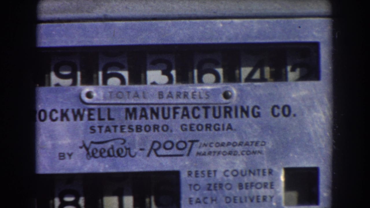 Close-up of a metal TOTAL BARRELS counter with Rockwell Manufacturing Co. text and rolling numerals.
