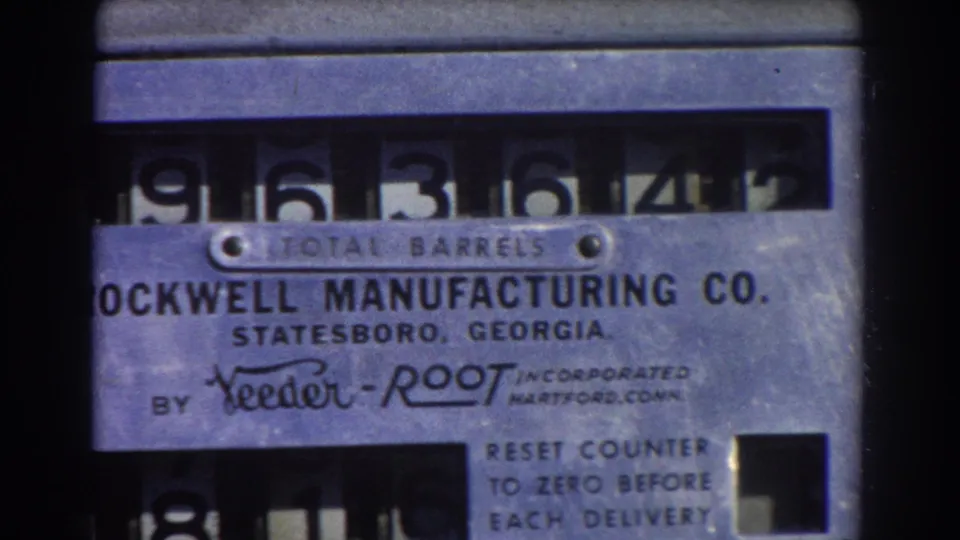 1967 Brisbane home-movie close-up of a Rockwell Manufacturing Co. TOTAL BARRELS mechanical counter with visible numerals and maker markings.