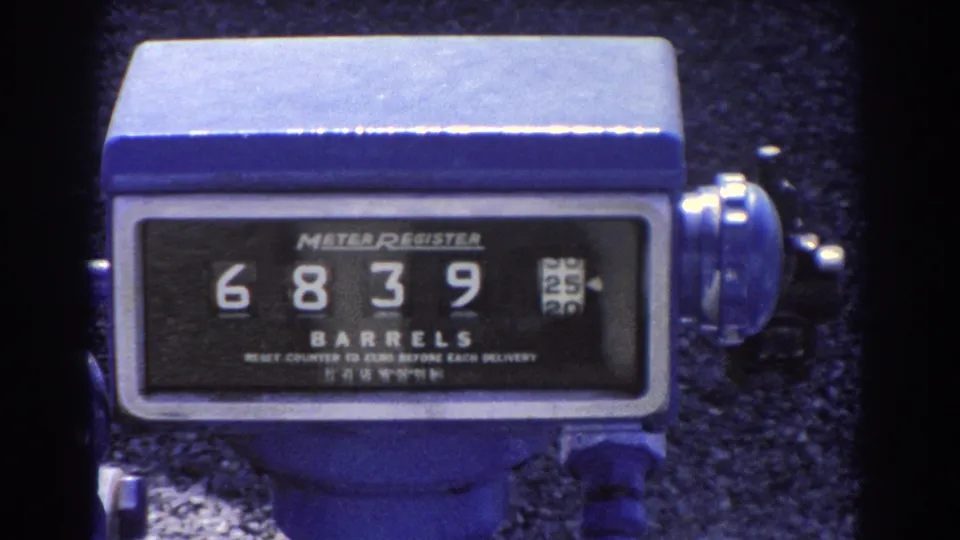 Close-up of a blue mechanical meter register at the Brisbane oil facility, with the counter showing 6839 barrels.