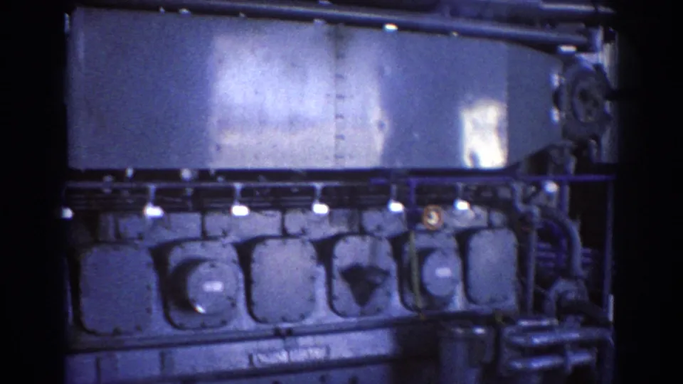 Close 8mm view of the industrial electrical machine in Brisbane, with round covers, pipework, bolted panels, and a visible brand area.