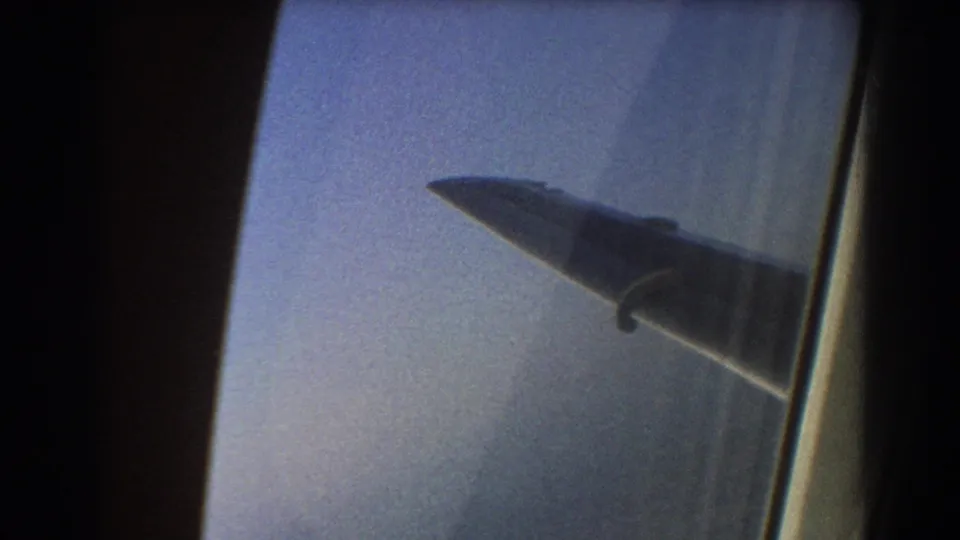 A second 1967 airplane-window frame shows the wing silhouetted against pale sky, with the window edge visible at right.
