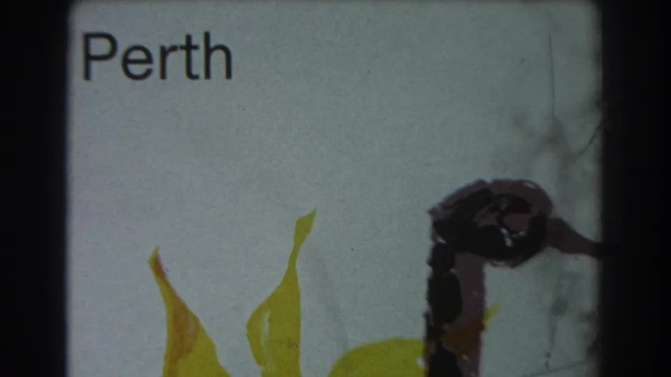 1967 8mm frame showing a white sign reading Perth with a yellow swan motif, filmed close enough for the lettering to be legible.