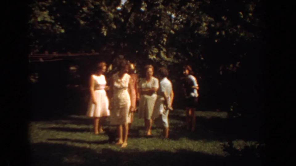 Visitor group in 1967 Fort Lauderdale stands on a grassy, shaded area near the wildlife enclosure.