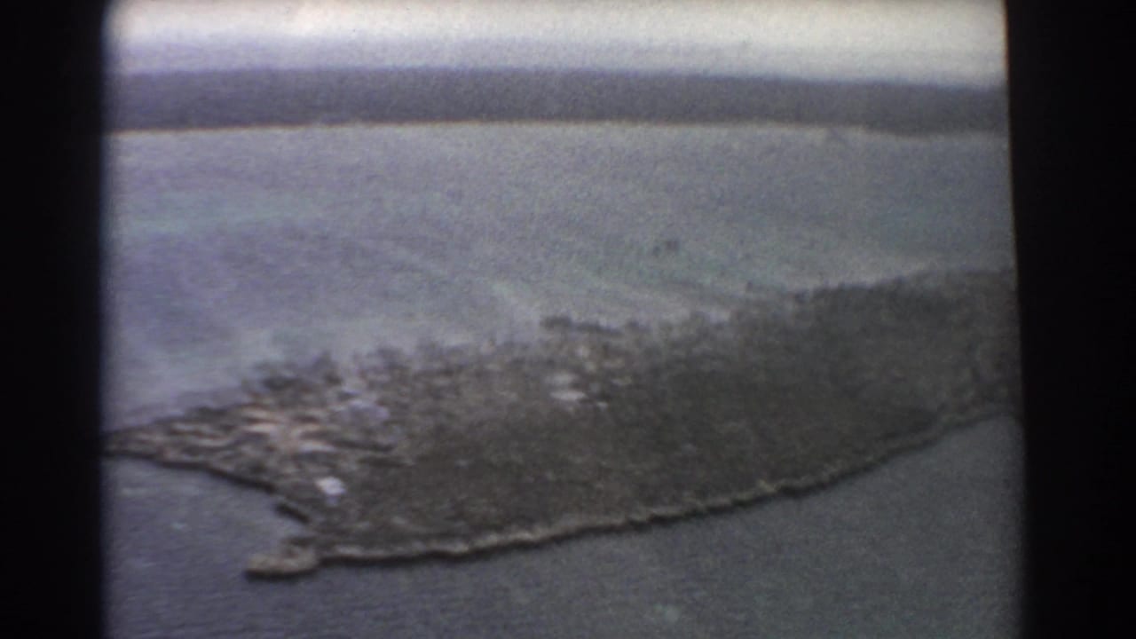 Aerial view of a rugged island or peninsula surrounded by blue ocean.