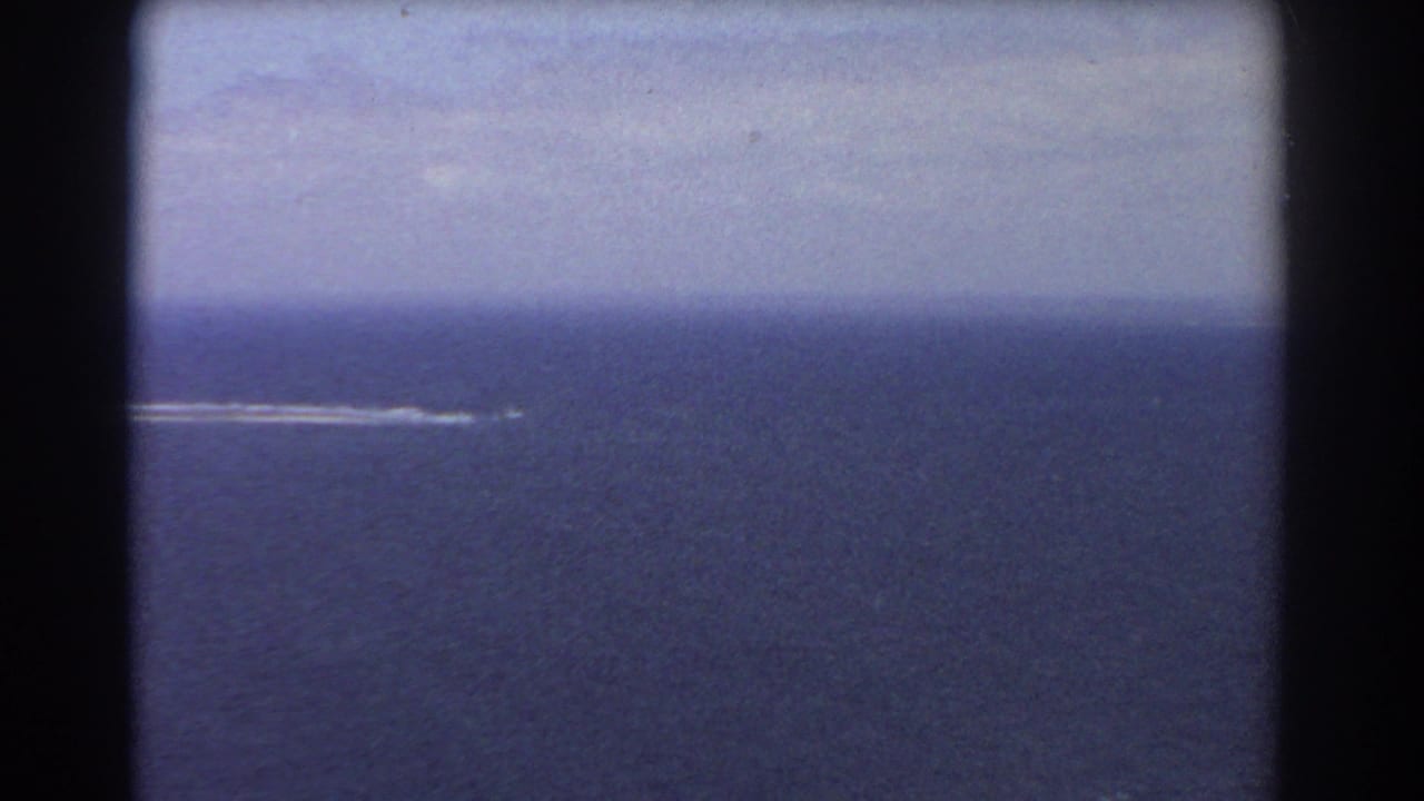 1967 Perth-area 8mm frame showing open blue ocean with a small distant white wake near the horizon.