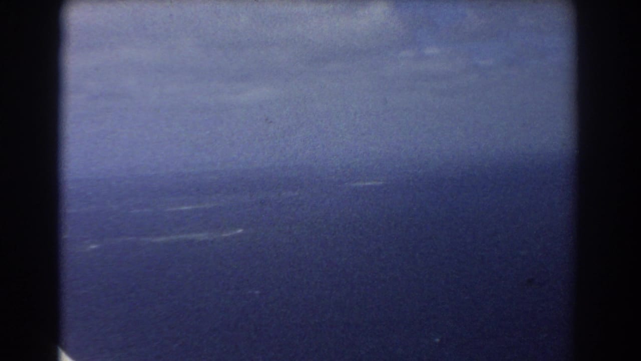 Soft 8mm view of blue sky and ocean, likely from a plane window over Perth, Australia, in 1967.