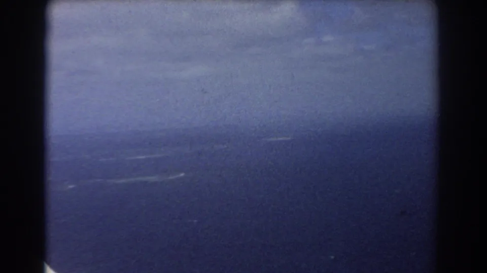 Soft 8mm view of blue sky and ocean, likely from a plane window over Perth, Australia, in 1967.