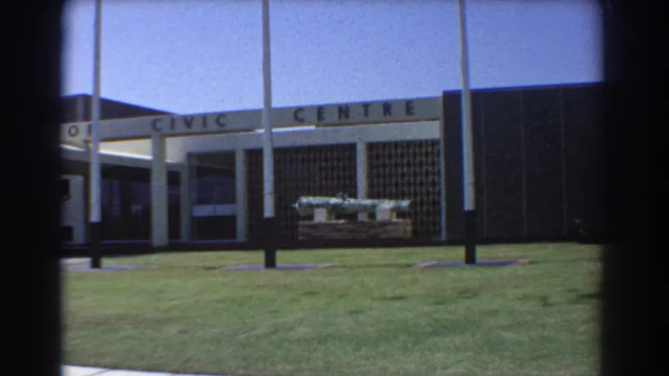 1967 Perth Civic Centre frontage, showing the sign, flagpoles, lawn, and cannon display from a visitor viewpoint.