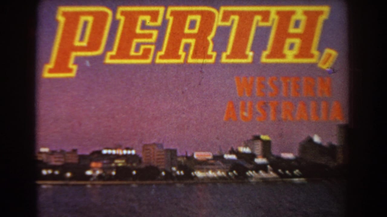1967 8mm frame with a large Perth, Western Australia title over a twilight city skyline beside water.