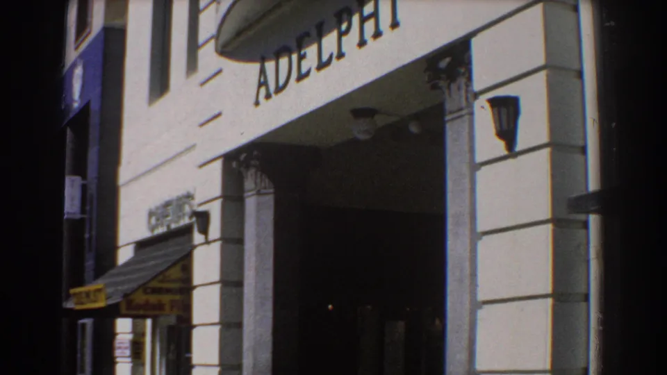 1967 Perth street-level view of ADELPHI lettering over a recessed entrance, with columns, lamps, an awning and a Kodak Film sign nearby.
