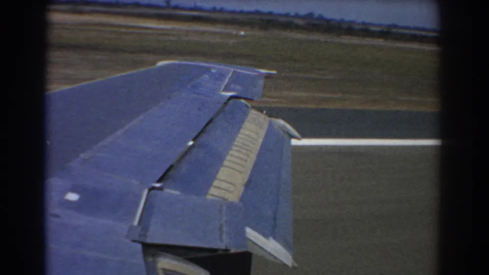 Blue aircraft wing over runway pavement with a white marking visible in the final 1967 Perth frame.