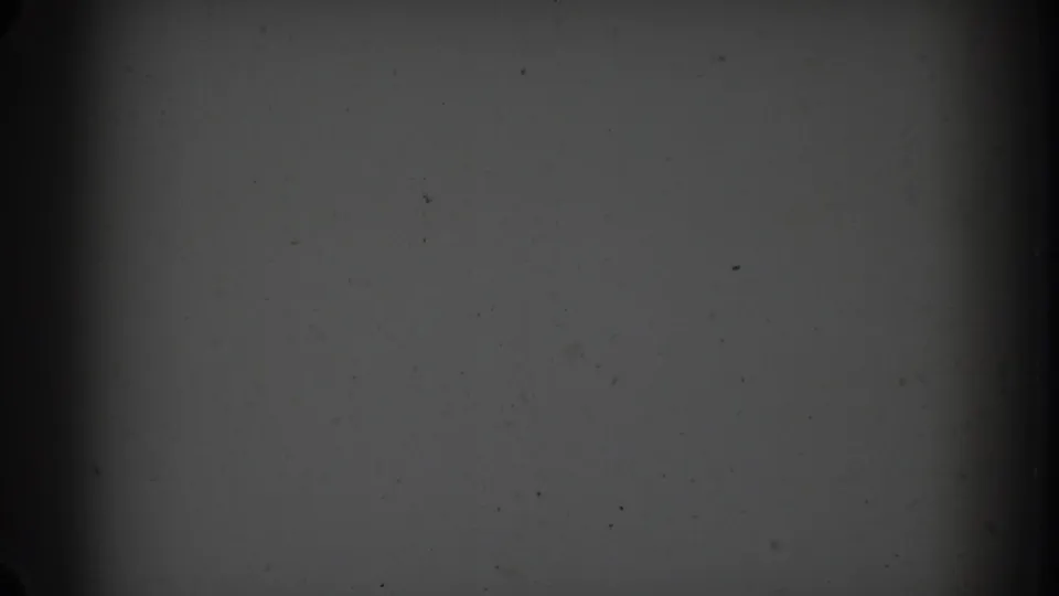 1967 Sydney 8mm frame showing a dim grey film field with heavy vignette, dust specks, and central vertical shading.