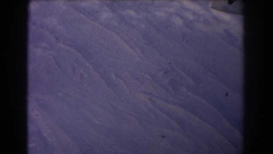 1967 8mm frame showing a blue-purple space-view surface with soft ridges, dust, scratches, and heavy black frame borders.