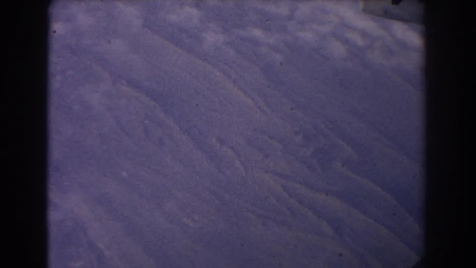 1967 8mm home-movie frame showing rugged mountain ridges near Sydney, Australia, with faded purple-blue color and gate edges.