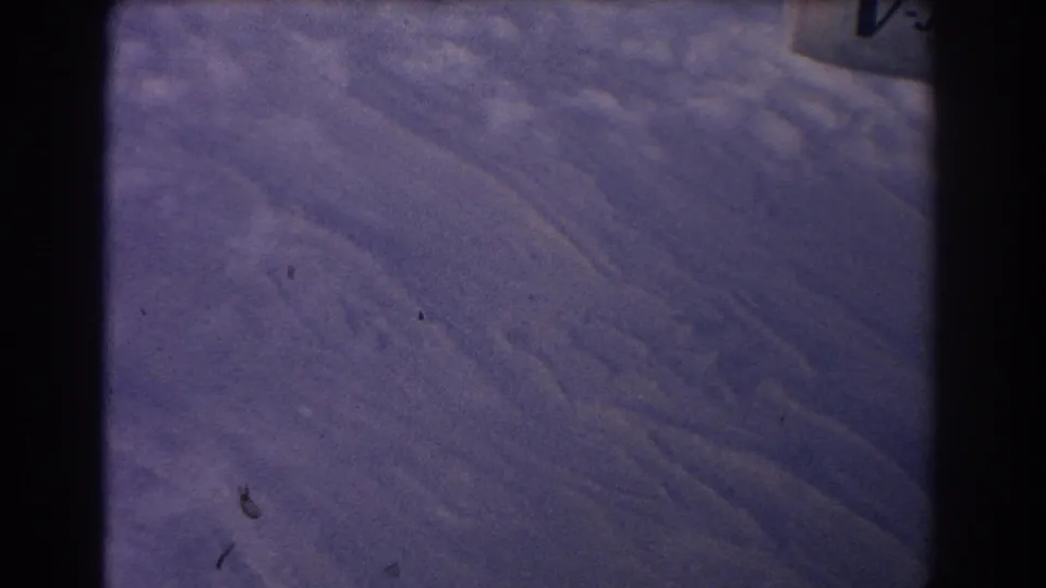 1967 8mm frame of rugged terrain near Sydney, Australia, marked by soft focus, dust specks, and a cool faded film cast.
