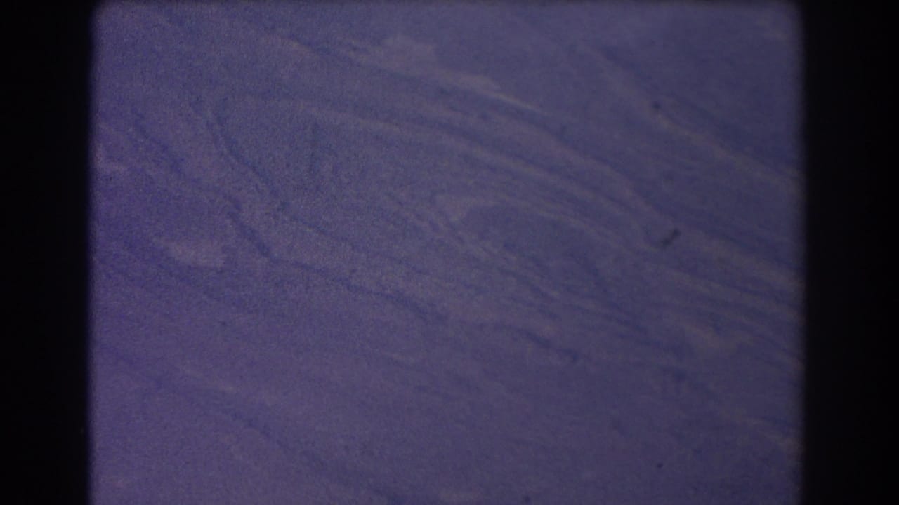 Soft aerial view of textured land patterns with dark 8mm frame edges.