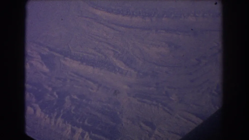 1967 Sydney-labeled 8mm frame showing a broad purple-blue surface with ridged bands and visible film borders.
