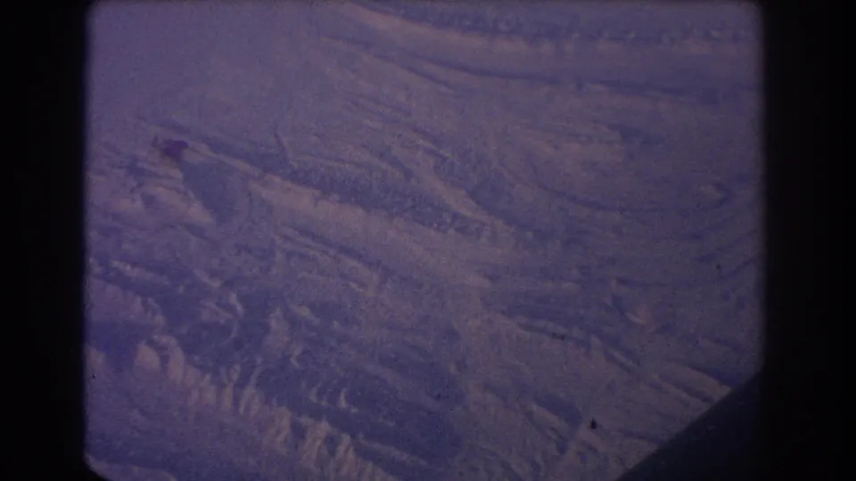 1967 Sydney-labeled 8mm frame with abstract ridges, mottled texture, and a strong dark edge from the film gate.