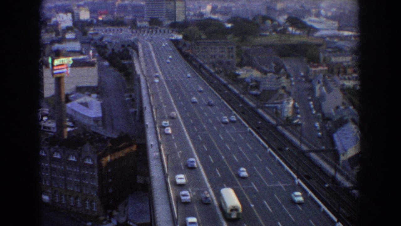 High-angle view of cars and a white bus on a multi-lane city highway.