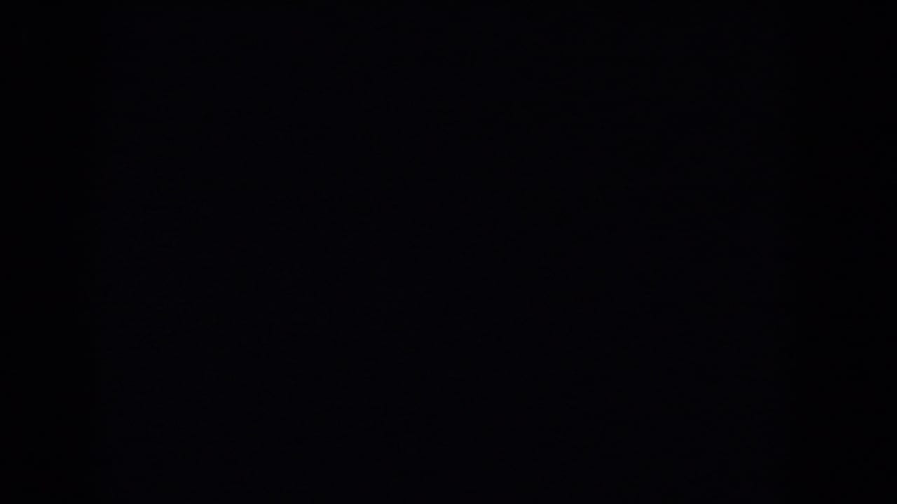 Mostly dark 8mm frame with no clear subject visible.