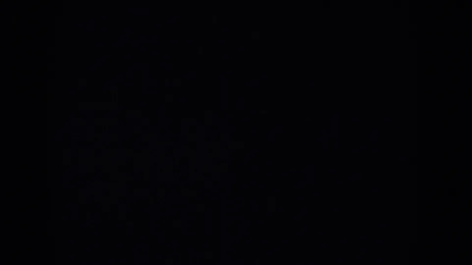 Dark opening frame from 1957 8mm home-movie footage, with no identifiable people or setting visible.