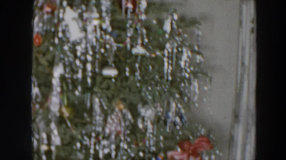 A late frame shows the 1957 Christmas tree decorations in Wheeling, Ohio, with tinsel and ornaments against curtains.