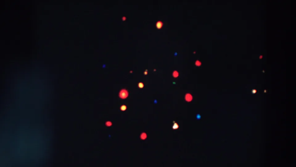 Soft 8mm night view from Wheeling, Ohio, showing clustered red and yellow illuminated decoration with small blue and green points.