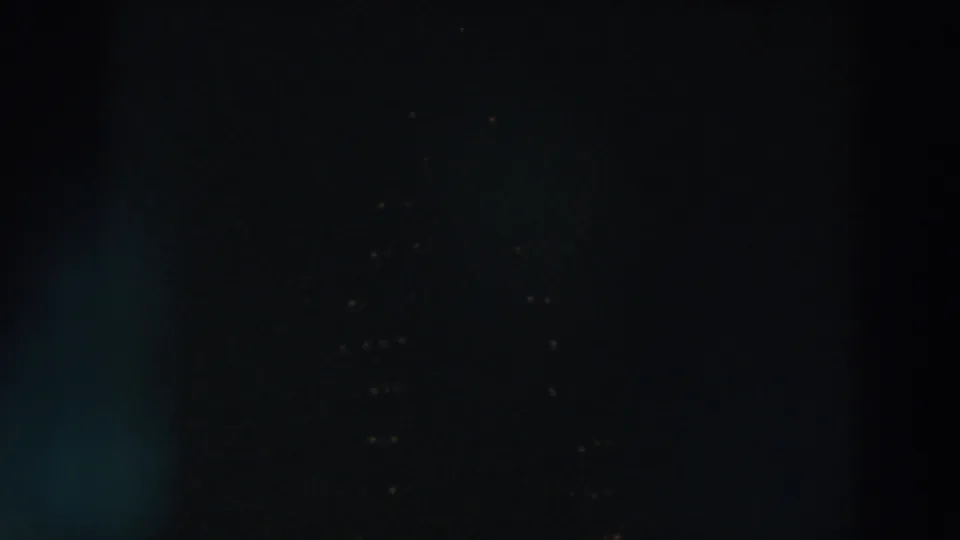 1957 Wheeling, Ohio 8mm frame with fading holiday bulbs barely visible in the darkness.