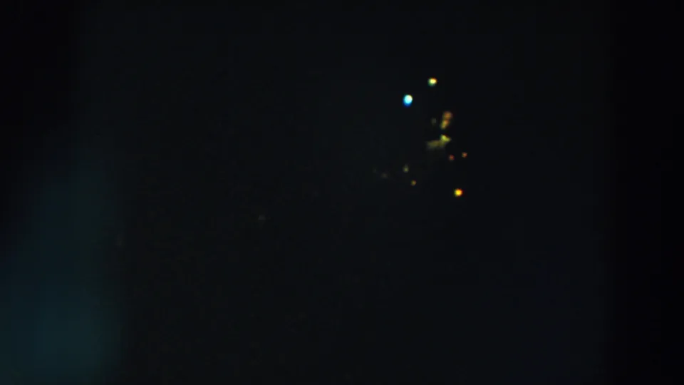 A dark 8mm frame shows scattered holiday lights and blue-green flare, consistent with the Wheeling, Ohio 1957 metadata.