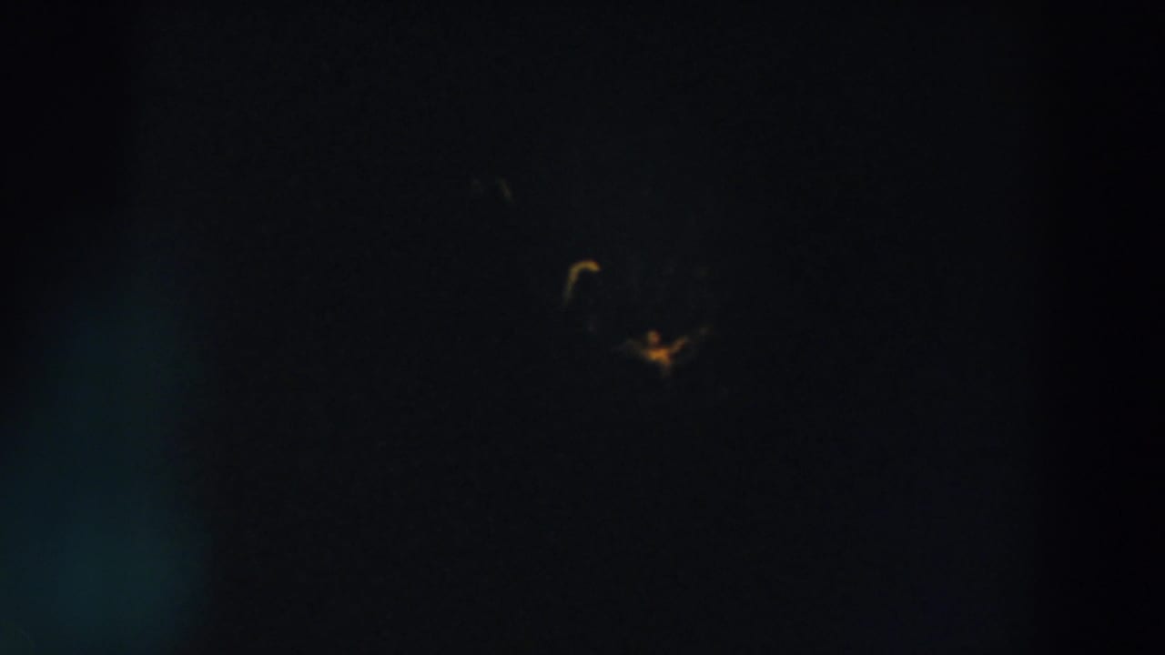 Extremely dark 8mm frame from Wheeling, Ohio, with a faint yellow light visible high in the night sky.