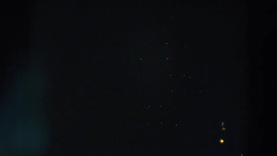 Dark 8mm Wheeling, Ohio frame showing faint colored specks and a small yellow antenna light near the lower right edge.