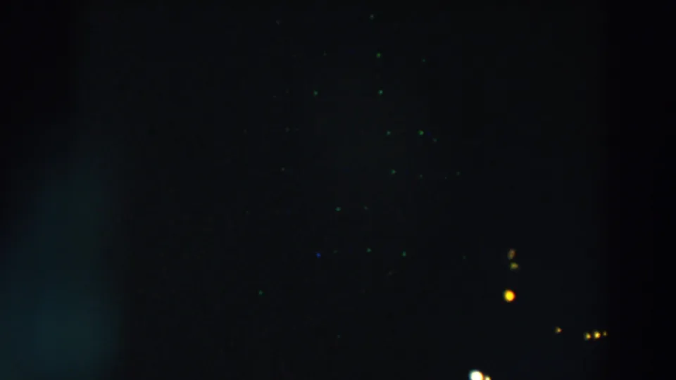 1957 Wheeling, Ohio 8mm night footage showing sparse distant lights in a mostly black frame with visible film grain.