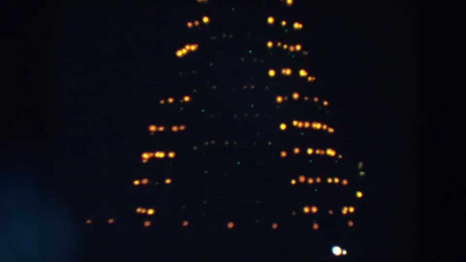 In Wheeling, Ohio home-movie footage from 1957, a soft triangular formation of yellow lights appears in darkness.