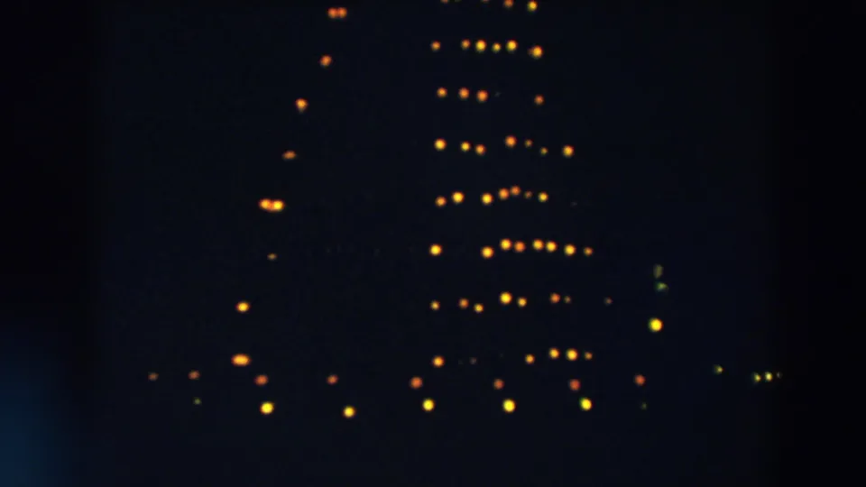 Near the end of the Wheeling, Ohio clip, partial rows of yellow lights remain visible as the formation shifts in darkness.