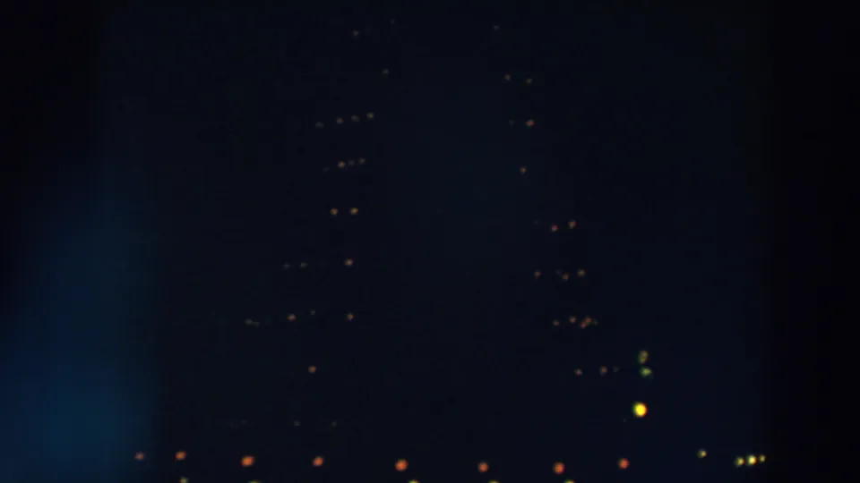 1957 Wheeling, Ohio home-movie frame showing faint distant lights against a very dark night scene.