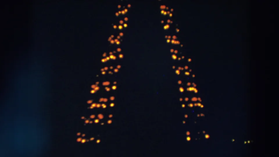 1957 Wheeling, Ohio frame with orange lights forming tall vertical patterns in the darkness.