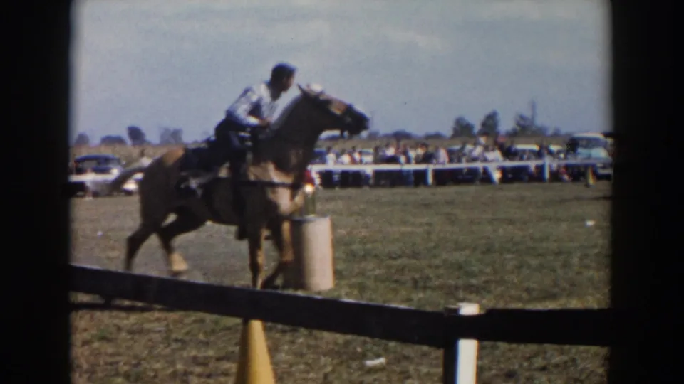 Near the end of the clip, the rider and horse pass close to a cylindrical course post in the 1957 Wheeling, Ohio home-movie footage.