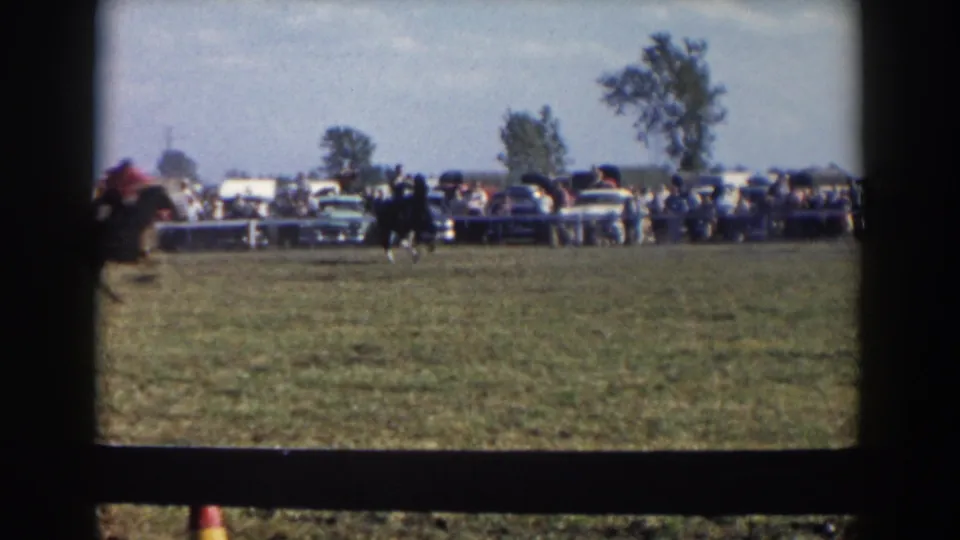 The final frame shows a horse and rider near the field edge in Wheeling, Ohio, with spectators, barriers, and parked 1950s cars behind them.
