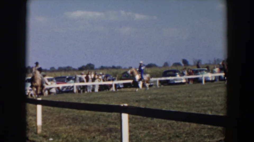 The final frame shows a rider and horse near the rail fence with spectators and parked 1950s cars in the Wheeling, Ohio fairground scene.