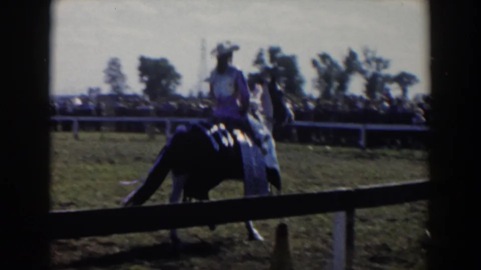 1957 Wheeling, Ohio 8mm view from behind the fence as the rider and horse move away across the show field.