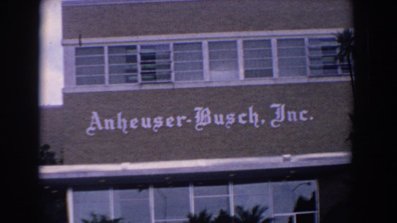 Anheuser-Busch, Inc. sign on a mid-century building facade with upper windows.