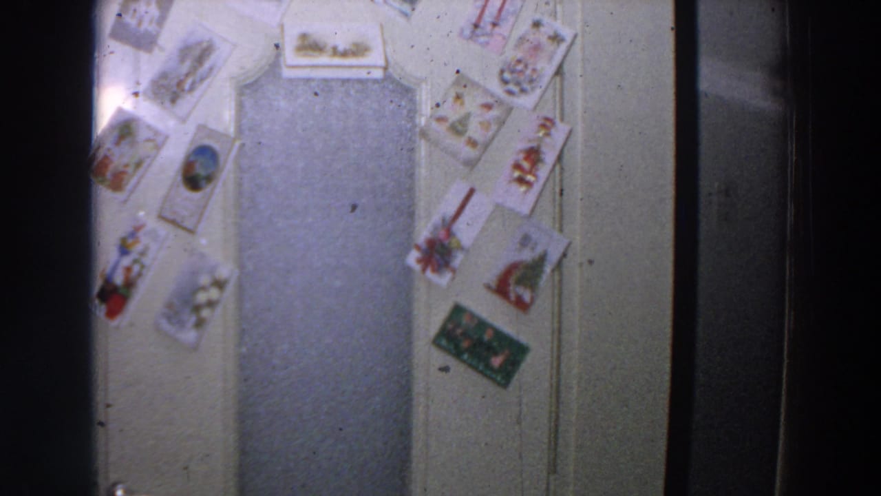 Interior door covered with postcards arranged around a central panel.